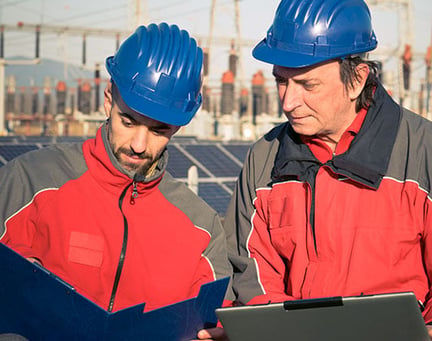 Two engineers in front of solar panels